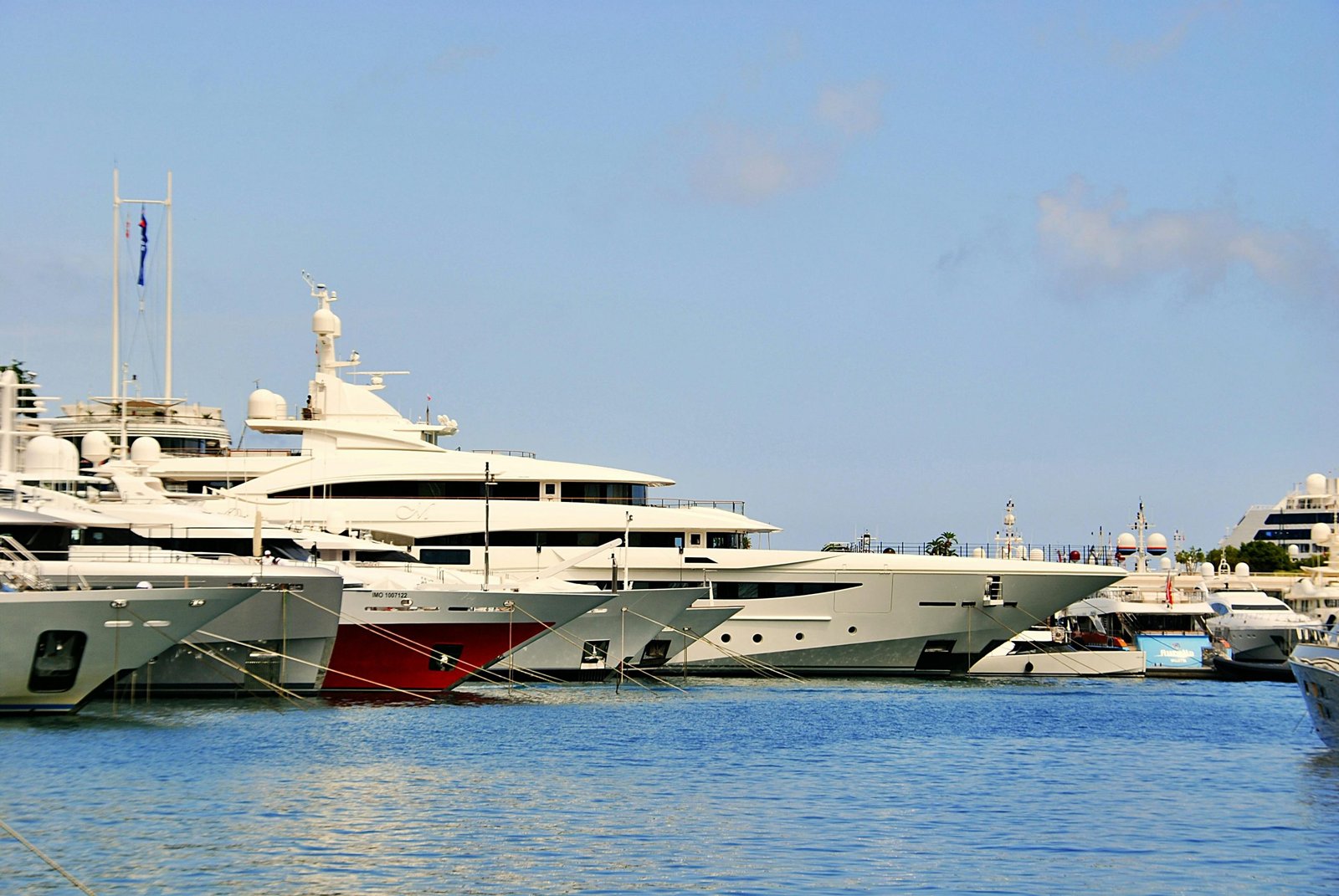 Stunning view of luxury yachts docked in the sunny Marina of Monaco.